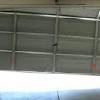 garage door installation,garage door damaged repair garage panels bent replace,steel garage doors, aluminum garage doors, wood garage doors, carriage style garage doors,replaced damaged sections with new panels,insulated garage door panels,panel broke loose from the metal bracket ripped Dented 